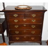 An 18th Century oak straight front chest of drawers with two short over three long graduated drawers