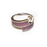 An 18 carat white gold pink sapphire and diamond crossover ring, finger size N