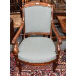 A Regency mahogany armchair, with over stuffed seat and raised on reeded scroll supports