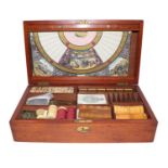 An Edwardian mahogany games compendium with fitted interior, including gaming boards, counters,