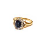 A sapphire and diamond cluster ring, stamped '18CT', finger size M1/2Condition report: The ring is