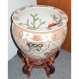 Reproduction Chinese fish bowl on a stand.