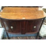 An early 20th century Georgian style mahogany bow fronted two door sideboard of small proportions,