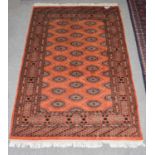 Pakistani Bukhara rug, the terracotta field with salor guls enclosed by narrow borders, 186cm by