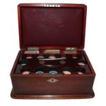 An early 20th century mahogany gaming box fitted with a gambling chip caddy, and compartments for