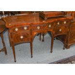 A George III crossbanded and inlaid mahogany serpentine sideboard