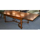 A late 19th century French walnut extending dining table, the quarter veneered and crossbanded