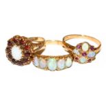 An opal five stone ring, stamped ‘18’, finger size Q; a 9 carat gold opal and garnet cluster ring,