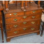 An 18th century oak four height chest of drawers, with brass handles and raised on bracket supports,