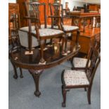 An early 20th century mahogany wind out dining table, 110cm by 180cm (open) 75cm W, plus