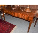 A George III mahogany serpentine fronted serving table fitted with three frieze drawers (repairs/