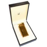 A Dunhill gold plated lighter with engine turned engraving and in fitted box