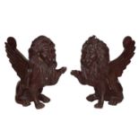 A pair of late 19th century cast iron models of rampant winged lions, 31cm H