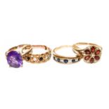 Four 9 carat gold gem set rings, including a garnet and diamond example, a sapphire and diamond