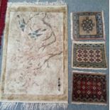 A Chinese silk mat, the ivory field of birds and flowers enclosed by pale gold borders, 92cm by