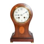 An Edwardian mahogany and inlaid balloon form mantle clock, striking on a gong, 29cm high