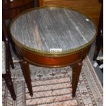 A 19th century French gilt metal mounted marble topped mahogany centre table, the circular top
