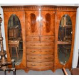 An impressive late Victorian mahogany triple wardrobe, the central bowed section with a pair of