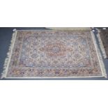 Kashmir rug, the ivory Herati field with central medallion framed by rust borders, 190cm by 122cm