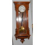 A mahogany veneered Vienna type wall clock, the enamelled dial with Roman numerals, lacking