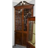 A George III mahogany astragal glazed standing corner cupboard in the Chippendale taste, with