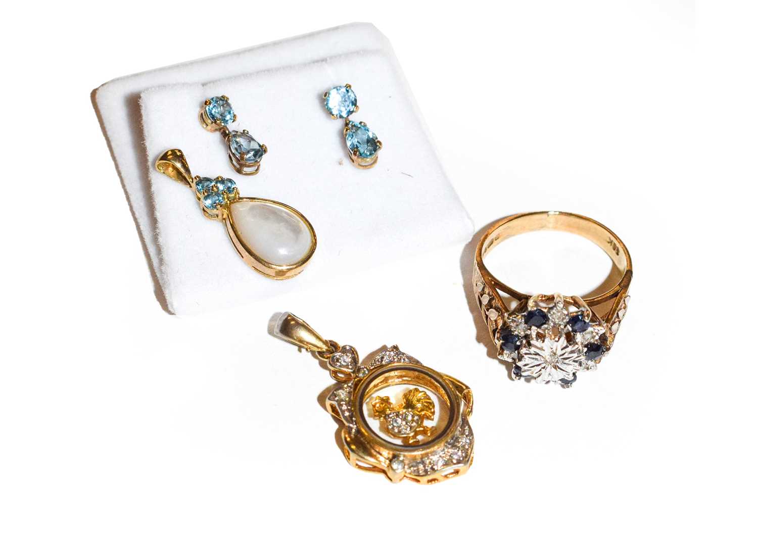 A 9 carat gold sapphire and diamond cluster ring, finger size P1/2; two gem set pendants; and a pair