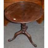 An 18th century mahogany tilt top tripod table, the dish top above a wrythen and baluster standard