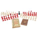 Two antique red and white chess sets, a black bishop, 1839 Chess Player's Hand Book, and 1903