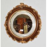 A circular oak and parcel-gilt framed wall mirror, the glass with cut hob nailed border, 49cm w