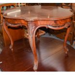 A modern Continental breakfast table with shaped top and carved legs, 130cm by 100cm by 77cm,