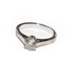 A diamond solitaire ring, the round brilliant cut diamond in a white double claw setting, to a