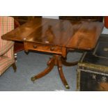 A 19th-century mahogany drop leaf pedestal table with opposing drawers