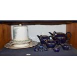 Tobias Harrison (b.1950) a set of nine graduated earthenware teapots with blue lustre glaze and gilt