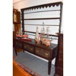 An 18th century oak dresser and rack, the date 1784 carved to the middle drawer