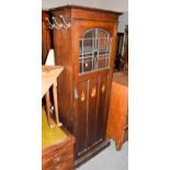 A Continental oak Arts & Crafts hall robe with figural inlay to the door, 76cm by 39cm by 194cm