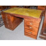 An early 20th century leather inset oak partners' desk of small proportions, 137cm by 81cm by 72cm