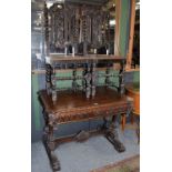 A Victorian carved oak library or centre table, circa 1870, of canted rectangular form, the carved