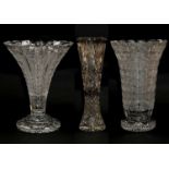Three large cut crystal vases, two of trumpet form and raised on circular plinths, tallest 46.5cm