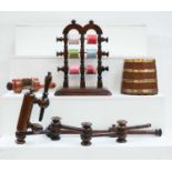 An early 20th century cotton reel stand, an articulated sewing clamp, two other sewing clamps and