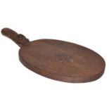 Workshop of Robert Mouseman Thompson, English oak cheeseboard, dark fume with carved mouse trademark