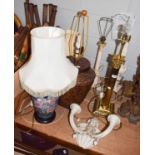 A brass based table lamp of Corinthian column form together with; a quantity of other table lamps to
