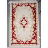 Indian 'Savonnerie' Rug, the ivory field with flower head medallion framed by floral borders, 183 cm