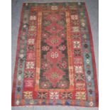 A Kilim, probably East Anatolia, the charcoal field with five stepped medallions enclosed by wide