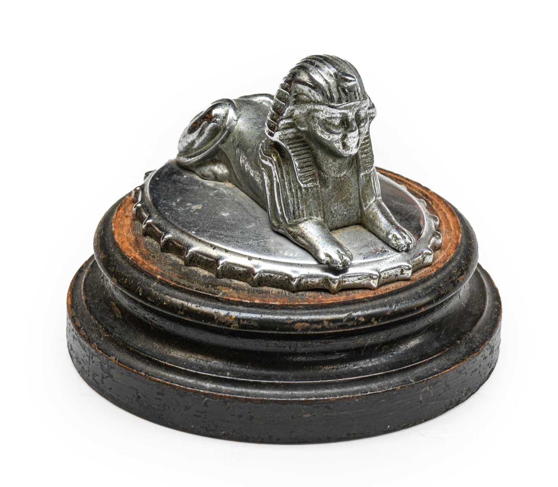 Armstrong Siddeley: An Egyptian Sphinx Car Mascot, mounted on a radiator cap and wooden base, 9cm