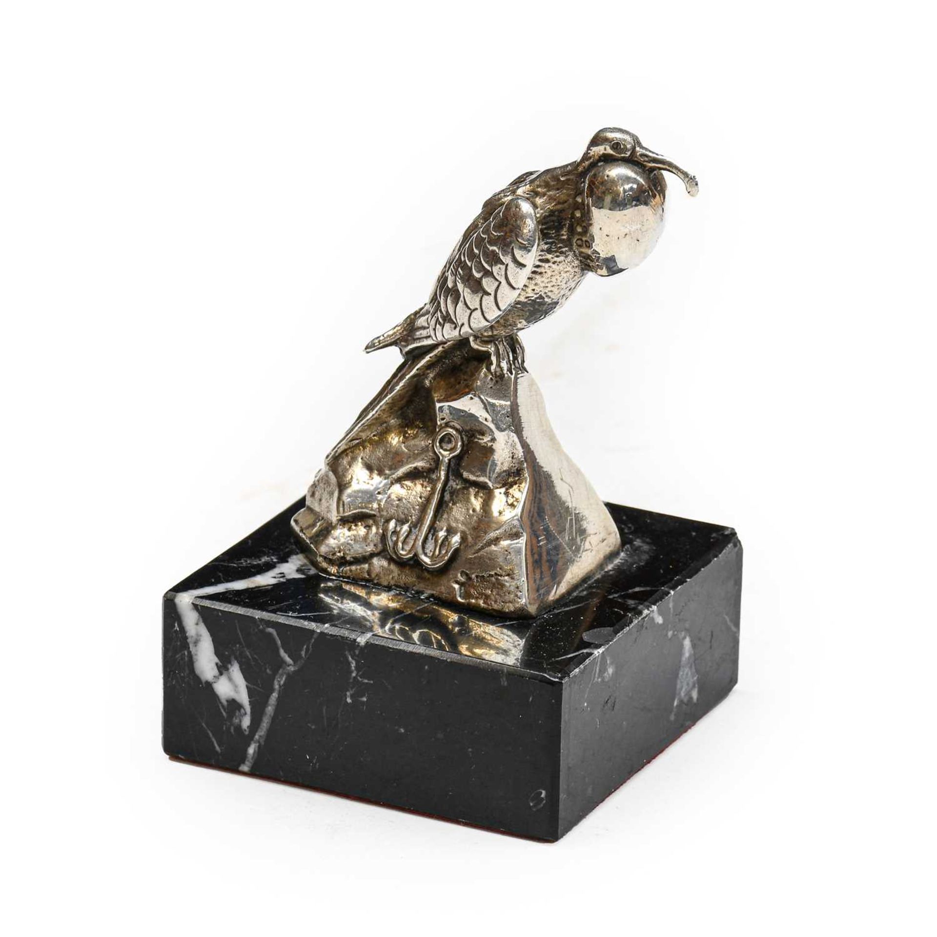 A Chrome-Plated Bird of Prey Car Mascot, standing on a rocky base, mounted on a later black marble