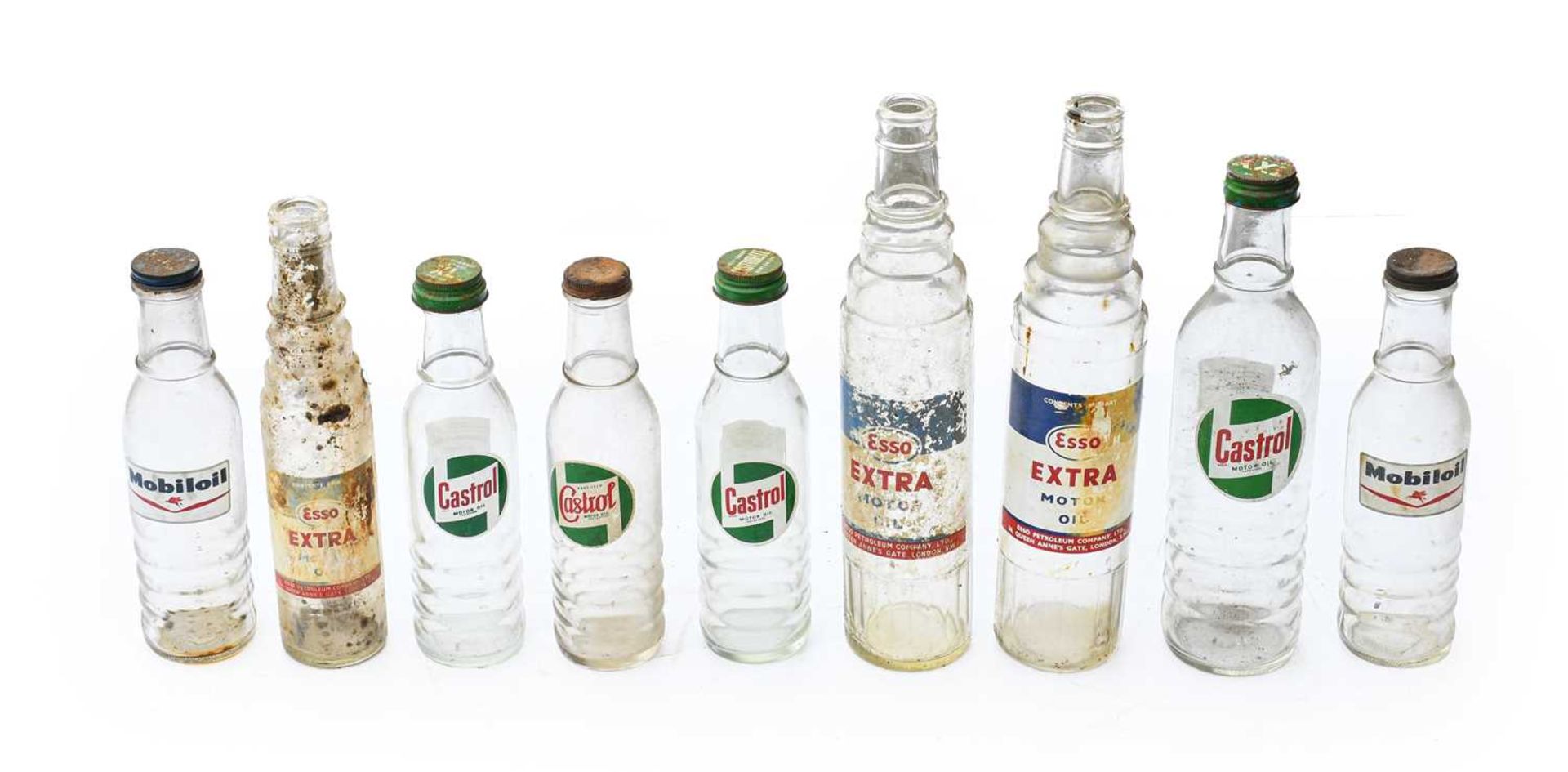 A Castrol Motor Oil XXL Clear Glass Bottle; Two Esso Extra Glass Bottles, each 38cm high; and Six