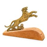 A Bronzed Accessory Mascot, as an outstretched lion, mounted on a wooden base