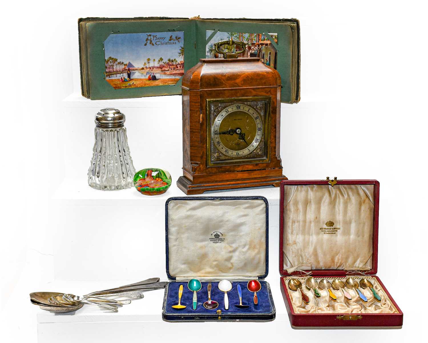 An Elliot mantel timepiece in a burr walnut case, together with a postcard album and contents, a