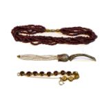 A garnet five strand bead necklace, length 38cm; a garnet bracelet, length 17.5cm; and a paste