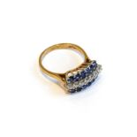 A 9 carat gold sapphire and diamond ring, a row of round brilliant cut diamonds flanked by rows of